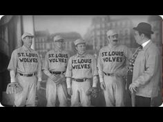 an old black and white photo of men in baseball uniforms with words on their shirts