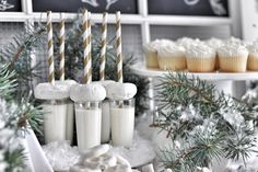 cupcakes and other dessert items are displayed in front of the christmas decorations on display