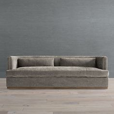 a couch sitting on top of a hard wood floor