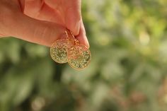 Botanical earrings made from real dried flowers and clear resin. A wonderful gift for nature lovers. Details: Size in diameter: 2 cm (Let me know if you want other size ) Material: Clear resin, real dried flowers Metal: Gold plated brass Ready to ship **Your new earrings will arrive safely packaged in beautiful bag with our logo, complete with a card. A wonderful gift for you and your loved ones. Usually delivery takes 20-40 days depends on country, but please be aware that it could sometimes ta Elegant Gold Earrings With Pressed Flowers, Dainty Pressed Flower Earrings For Wedding, Elegant Round Earrings With Pressed Flowers, Delicate Pressed Flower Earrings, Gold Pressed Flower Earrings For Wedding, Delicate Round Earrings With Pressed Flowers, Dainty Round Earrings With Pressed Flowers, Handmade Gold Earrings For Bridesmaid Gift, Handmade Gold Earrings For Bridesmaids