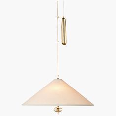 a light fixture with a white shade hanging from it's side and a gold rod on the end