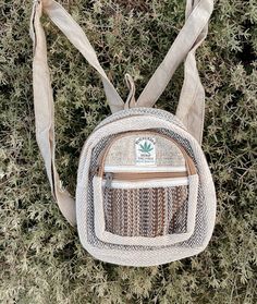 "This mini hippie hemp backpack is the ultimate boho vibe! Perfect for travel, diapers, water, festivals, the beach or grocery store trips! Mini size but holds books, clothing and water! : 9\"x9\" Made with 100% hemp and handcrafted. NOTE: Colors may vary since each is handmade and one of its kind!"