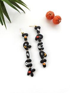 These earrings were designed for Halloween and they will be a unique complementary and eye-catching piece of the Halloween season. I am so excited to be able to share these trick-or-treat earrings with you because they are my own design and they are one of a kind. **Very lightweight and unique earrings.  A beautiful statement piece that is so comfortable, you'll forget you have them on! All findings are hypo-allergenic and nickel free. and colorfast. Material : 24k gold plated ,polymer clay Please feel free to contact me with any queries about my jewellery! Please check my other jewellery too: https://www.etsy.com/shop/Viviendesignstudio Visit me on Instagram too - I'm looking forward to you! : https://www.instagram.com/viviendesign_/ Whimsical Black Earrings For Party, Whimsical Black Party Earrings, Fun Handmade Black Earrings, Handmade Black Halloween Earrings, Handmade Fun Black Earrings, Handmade Witchy Earrings For Halloween, Black Halloween Earrings Gift, Fun Halloween Dangle Earrings, Spooky Black Drop Earrings