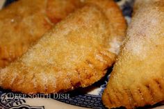 two fried pastries sitting on top of a plate