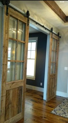 an empty room with wooden floors and sliding doors