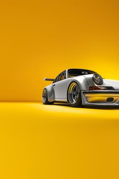 a white sports car on a yellow background