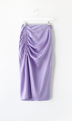 Made up of a lush satin fabric, the Claudia Midi Skirt features an adjustable gathered slit that's classy and flattering. Pull the strings tighter for a more draping texture and a shorter skirt or extend the for a modest approach to your look. The light violet color and silhouette of the dress truly shine when worn with a tight-fitting top and a pair of your favorite heels. Ruched skirt Satin Midi Front slit Invisible zipper Lined Length: 30" Waist: 13 1/2" Hips: 19 1/4" Self: 100% Polyester Lin Pvc Skirt, Ruched Midi Skirt, Skirt Satin, Light Violet, Violet Color, Ruched Skirt, Luxury Women Fashion, Invisible Zipper, High Waisted Shorts