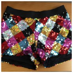 Multi color diamond sequin dance shorts with black elastic waistband. Multicolor Sequined Party Bottoms, Black Summer Bottoms With Contrast Sequin, Black Contrast Sequin Summer Bottoms, Black Contrast Sequin Bottoms For Summer, Fitted Multicolor Party Shorts, Disco Style Shorts For Night Out, Stretch Sequin Shorts, Disco Stretch Shorts For Night Out, Stretch Disco Shorts For Night Out