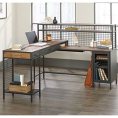 an office desk with metal meshwork and wooden shelves on the sides, along with a laptop computer