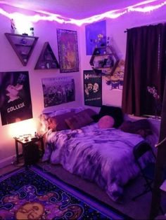 a bedroom with purple lights and posters on the wall