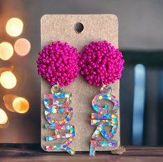 Get ready to party in style with our festive confetti dotted acrylic birthday girl earrings, topped with a playful fuchsia beaded accent. Designed to add a pop of color and whimsy to your birthday celebrations, these earrings are sure to make you feel like the belle of the ball. Each earring features a vibrant confetti dotted acrylic design that exudes fun and excitement, capturing the joyous spirit of your special day. Topping off these delightful earrings is a charming fuchsia beaded topper, a Trendy Beaded Earrings For Party, Playful Purple Party Earrings, Playful Pink Earrings For Birthday, Playful Pink Birthday Earrings, Fun Handmade Beaded Earrings For Party, Handmade Fun Beaded Earrings For Party, Fun Purple Earrings For Party, Playful Personalized Earrings For Birthday, Personalized Playful Earrings For Birthday