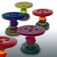 several different colored buttons sitting on top of each other in the shape of an object