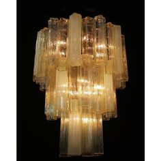 a large chandelier made out of glass blocks with lights in the middle and bottom