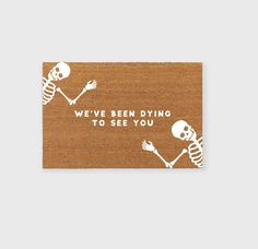 a sticker that says we've been dying to see you with two skeletons holding hands