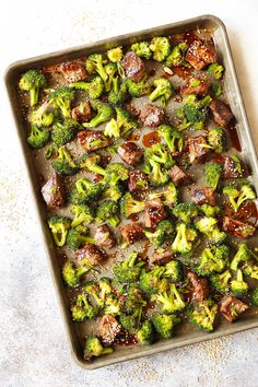 a pan filled with cooked broccoli on top of a table