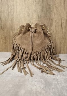 Italian Real Suede Leather Dark Beige Fringe Tassel Crossbody Bag Suede Leather Dark Beige Shoulder bag Fringe bags Beige Suede Bags Drawstring Closure Internal zipped pocket  Gold tone metal hardware  Detachable /Adjustable strap Fully lined inside  Soft Italian Real Suede Leather  Dimensions: H25cm x L25cm x D15cm Travel Bucket Bag With Tassels And Crossbody Shape, Travel Bucket Bag With Tassels In Brown, Crossbody Bucket Bag With Tassels For Travel, Chic Brown Hobo Bag With Tassels, Travel Crossbody Bucket Bag With Tassels, Trendy Leather Shoulder Bag With Tassels, Daily Use Brown Bucket Bag With Tassels, Brown Bucket Bag With Tassels For Everyday, Trendy Beige Shoulder Bag With Fringe