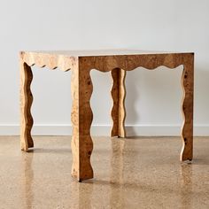 a wooden table sitting on top of a floor