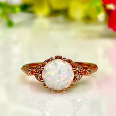 a white opal ring sitting on top of a table