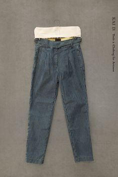 Japanese wabash striped denim washed in medium blue. High waisted pants (based on Isa pants with no pleats and longer inseam). Made in New York. Size S: waist 28" inseam 28" bottom opening 13" Size M: waist 30" inseam 28 1/2" bottom opening 13 1/2" SizeL : waist 32" inseam 28 1/2" bottom opening 14"