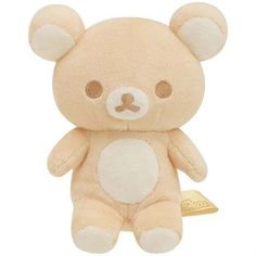 a brown teddy bear sitting on top of a white floor next to a gold bar