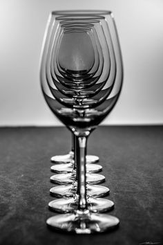 a row of wine glasses sitting on top of a table