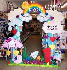 the entrance to a party candy store decorated with clouds and rainbows, umbrellas and hearts