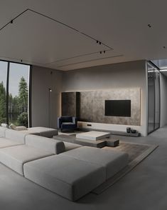 a modern living room with white furniture and large windows looking out on the trees outside