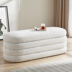 a stack of white towels sitting on top of a wooden floor