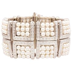 The pearl and diamond cuff bracelet of geometric design features sixteen sections each set with 9 Japanese Akoya pearls for a total of 126 lustrous pearls of 5 mm diameter. The bridges connecting these sections are set with a total of 15.20 carats of round diamonds of top quality (F/G-VVS, color, clarity and cut). The elegant bracelet is one-of-a-kind. It was entirely handmade in Italy with exquisite openwork craftsmanship and knowhow by maestro Salvatore according to an original design by Ella Vintage Pearl Bracelet, Pearl Bangles, Diamond Cuff Bracelet, Vintage Cuff Bracelet, Pearl Cuff Bracelet, Pearl Cuff, Pearl Bracelets, Pearl Accessories, Bracelets Design