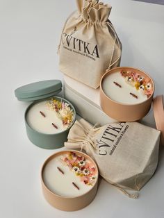 three candles are sitting on a table next to a bag