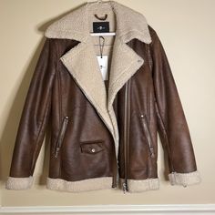 Never Worn Pleather Sherpa Bomber Jacket. Fall Leather Jacket With Fleece Lining, Fleece-lined Leather Jacket For Cold Fall Weather, Brown Leather Sherpa Jacket, Fitted Brown Shearling Leather Jacket, Brown Shearling Aviator Jacket, Brown Shearling Biker Jacket With Padded Collar, Rugged Brown Shearling Outerwear, Sherpa Lined Jacket, Sherpa Lined