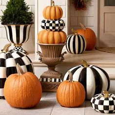 pumpkins and gourds are sitting on the front porch for fall decorating