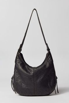 Silence + Noise utility washed shoulder bag. Tumble-washed soft faux leather bag in an everyday carry silhouette. Zippered top with tons of zip pockets at the front for all your essentials. Find it only at Urban Outfitters. Features Silence + Noise utility washed shoulder bag Zippered faux leather bag UO exclusive Content + Care PU Spot clean Imported Size Dimensions: 12.59" l x 2.75" w x 9.05" h Strap drop: 13.77" | Silence + Noise Utility Washed Shoulder Bag in Black, Women's at Urban Outfitte Casual Textured Leather Hobo Bag For Everyday Use, Urban Outfitters Bag, Faux Leather Bag, Black Leather Purse, Zipper Top, Everyday Carry, Leather Purses, Capsule Wardrobe, Leather Bag