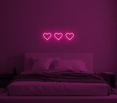 a bed with two hearts on the wall above it