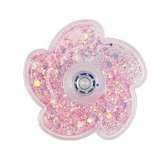 a pink flower shaped object with lots of glitters on the petals and in front of a white background