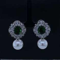 Elevate your elegance with our Gold Plated CZ Victorian Design Earrings. Inspired by the intricate beauty of the Victorian era, these earrings feature dazzling cubic zirconia (CZ) diamonds that sparkle with a timeless allure. A delicate pearl dangles below, adding a touch of sophistication and movement. The regal emerald gemstone accentuates the design, infusing a rich burst of color. These exquisite gemstone earrings are a perfect choice for brides seeking a touch of vintage charm or anyone des Elegant Cubic Zirconia Earrings With Stone Setting, Elegant Drop Earrings With Stone Setting, Elegant Green Pearl Earrings For Celebration, Elegant Bridal Earrings With Stone Setting, Classic Green Earrings For Wedding, Cubic Zirconia Earrings With Stone Setting, Elegant Bridal Earrings With Stone Setting For Formal Events, Party Earrings With Cubic Zirconia Stone Setting, Green Drop Diamond Earrings For Wedding