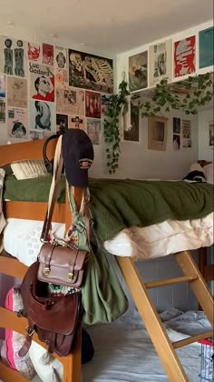 there is a bunk bed with many pictures on the wall and a bag hanging from it