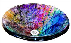 a glass sink with colorful designs on it