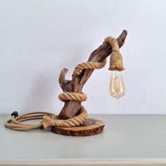 a lamp that is sitting on top of a wooden table next to a light bulb