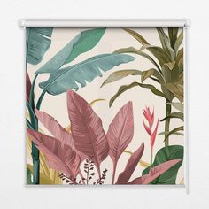 a wall hanging on the side of a white wall next to a window with plants and leaves