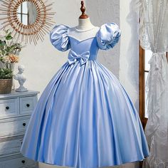 Expertly crafted with a satin fabric, this Princess Jewel Neck dress in Blue is designed for special occasions such as baptisms, weddings, and holidays. The beaded and bow embellishments add a touch of elegance to this floor length dress, while the short puff sleeves and crossed straps provide both comfort and style. Princess Dresses Kids Ball Gowns, Jewel Neck Dress, Long Flower Girl Dresses, Satin Flower Girl Dress, Princess Dress Up, Kids Gown, Princess Ball Gowns, Blue Birthday, Satin Flowers