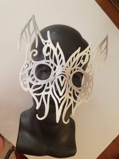 This handcrafted filigree mask was drawn in India ink, and the converted to 3D to print. It is lightweight, comfortable, and looks great for your victorian-era, Renaissance, or any other owl costume. Request any custom color paint job. Handmade Fantasy Halloween Mask, Artistic White Masquerade Mask For Halloween, Handmade Fantasy Eye Mask, Artistic White Costume Mask, Artistic White Masks For Costumes, Artistic White Costume Masks And Prosthetics, Artistic White Masks And Prosthetics For Costume, Handmade Fantasy Costume Masks, Handmade Fantasy Masks For Masquerade