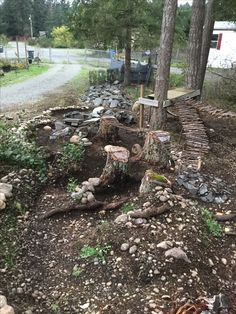 a tree that has been cut down in the middle of a yard with rocks around it