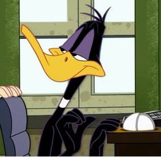 a cartoon character is sitting at a desk with his feet in the air and one hand on his head