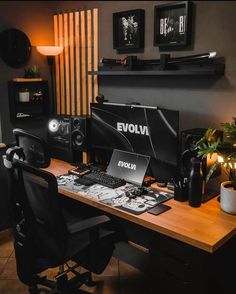 a desk with a computer and speakers on it