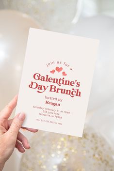 someone holding up a card for valentine's day brunch