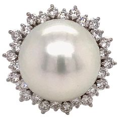 18K White gold ring featuring one South Sea Pearl measuring 14-15 mm flanked with 28 round brilliants weighing 0.98 carats. Color: G-H Clarity: SI Measurements: South Sea Pearl: 14-15 MM Diameter: 20.8 MM Height On Finger: 16.1 MM Ring is sizeable upon request. Pearl can be changed to Golden, Pink or Tahitian. Pearl And Diamond Ring, Floral Ring, Sea Pearl, Bracelet Design, South Seas, South Sea Pearls, Sea Pearls, Pearl Diamond, White Gold Ring