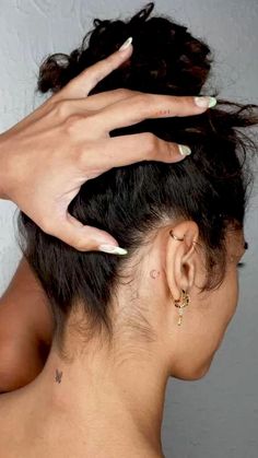 a woman's hand on top of her head while she is getting her hair done