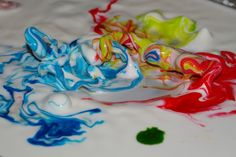 three different colored candies sitting on top of a white table covered in confetti