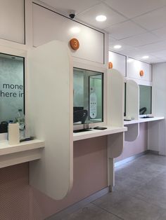 an office cubicle with multiple sinks and mirrors